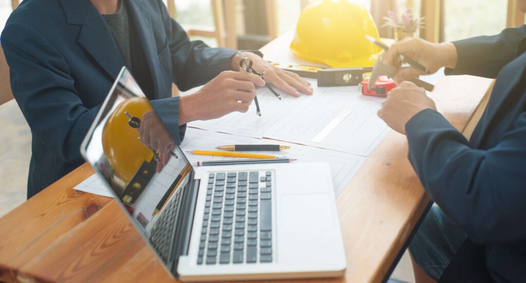 Consultants discussing a time impact analysis for a construction project